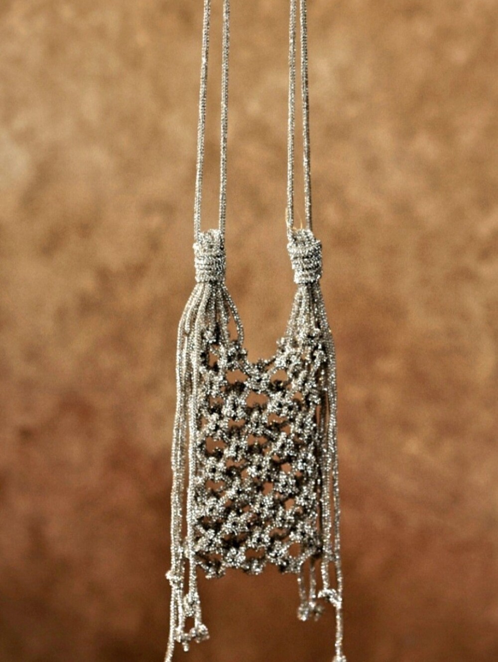  Ornate, handcrafted phone bag In Silver Finish.